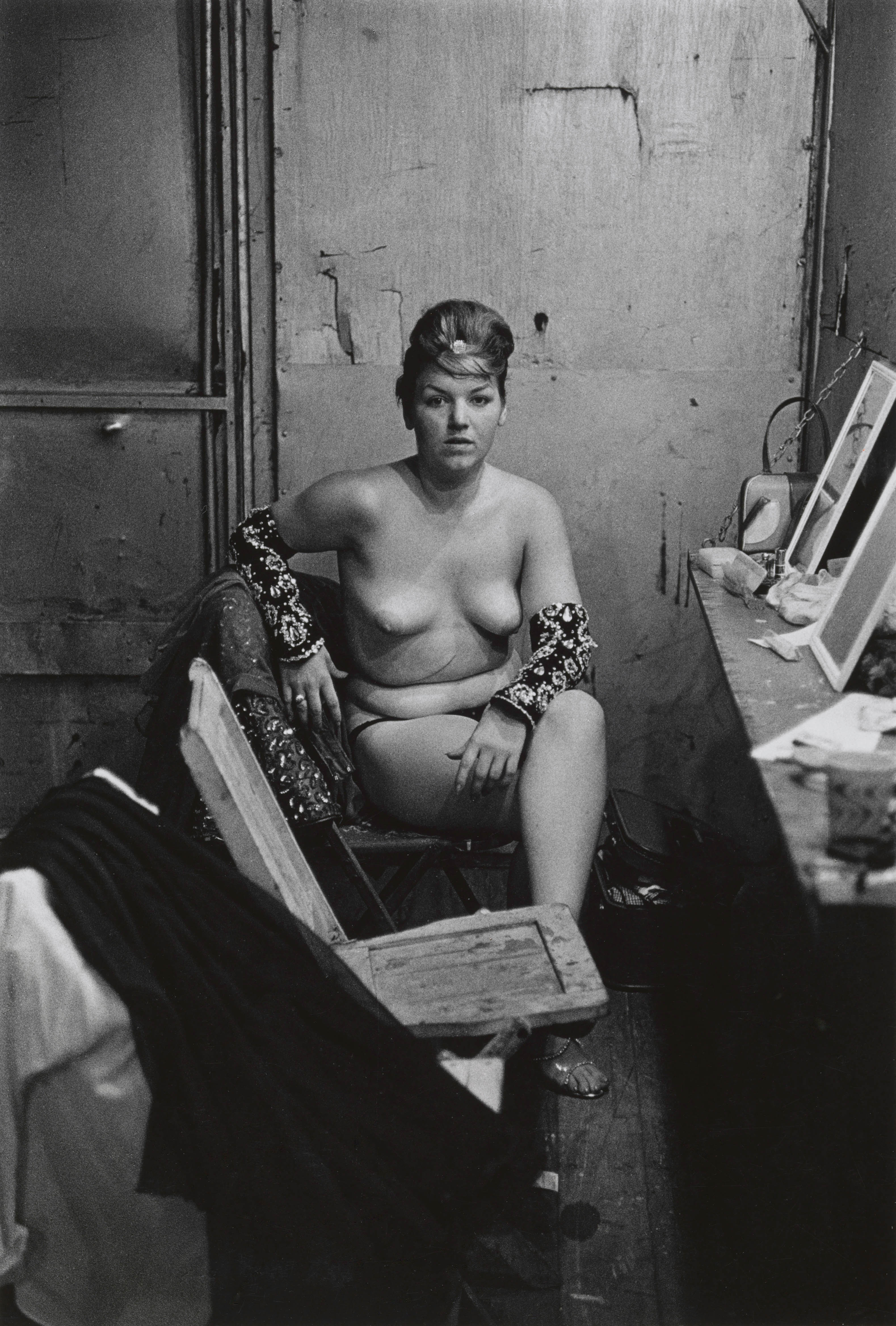 Diane Arbus. Stripper with bare breasts sitting in her dressing room, Atlantic City, NJ 1961. Gelatin silver print. 9½ × 6½ in. © The estate of Diane Arbus, LLC. All rights reserved.